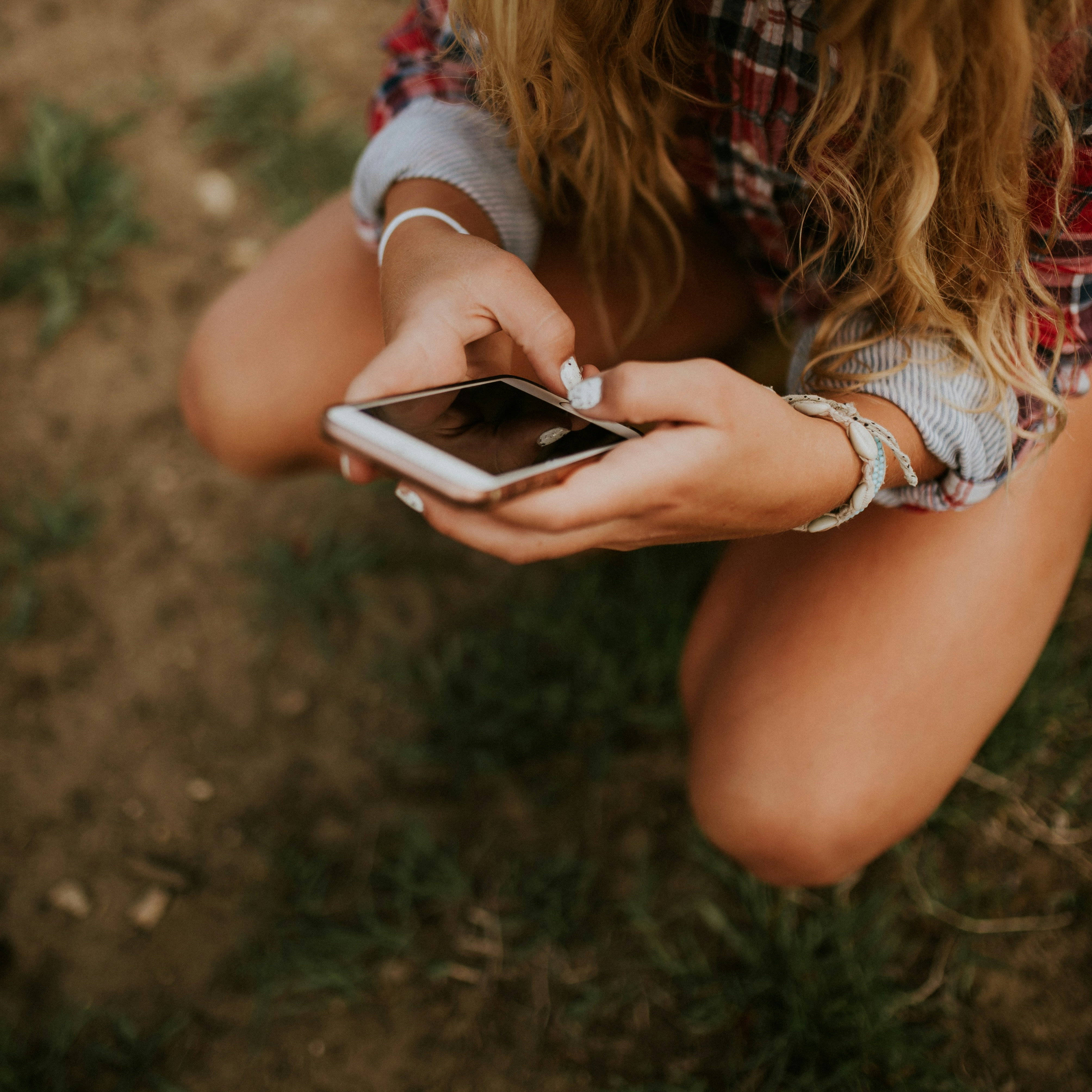 Person with high screentime holding their smartphone