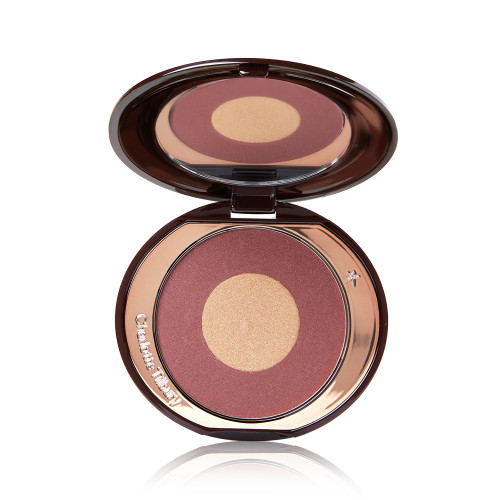 An open, two-tone powder blush compact in berry-pink and honey gold shades. 