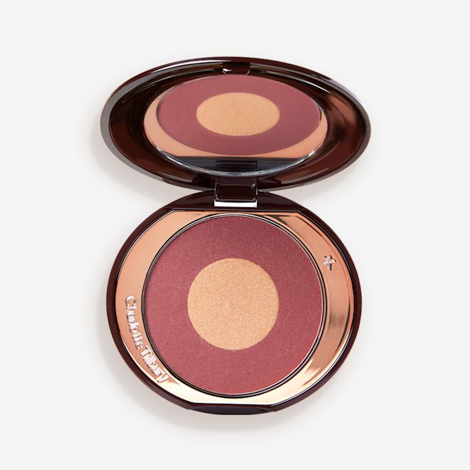Cheek To Chic in Walk of No Shame open An open, two-tone powder blush compact in berry-pink and honey gold shades.