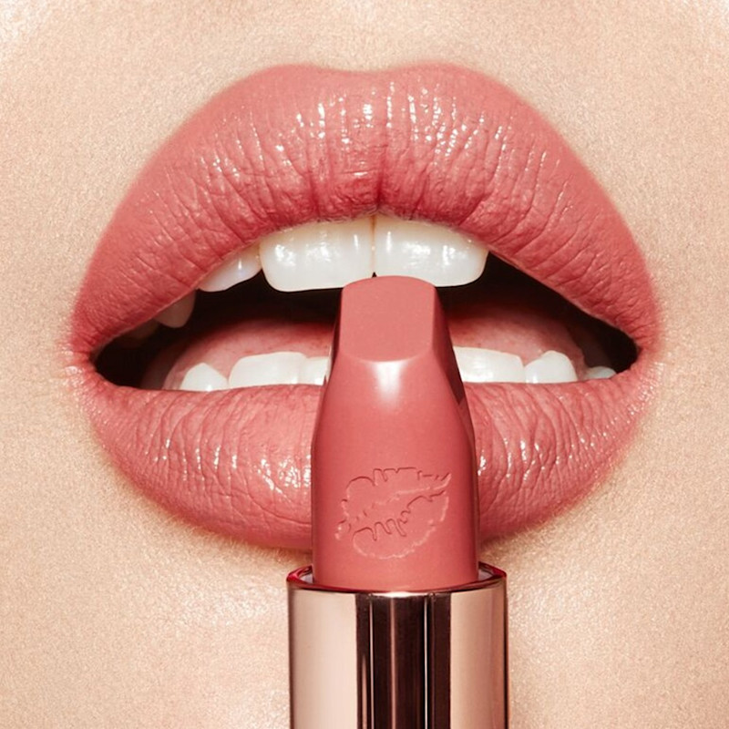 Lip close up of In Love With Olivia bubblegum pink lipstick on fair skin