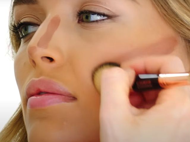 A medium-tone model getting her face contoured. 