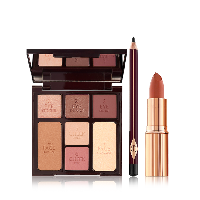 An open mirrored-lid face palette with three matte and shimmery eyeshadows, two blushes, and concealer powder, and bronzer with an eyeliner pencil in black, and lipstick in dark terracotta in a golden-coloured tube. 