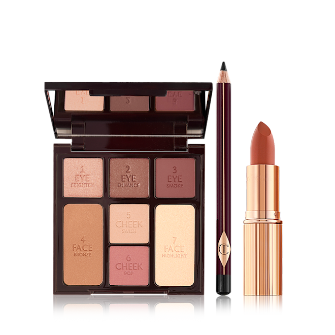 Instant Look in a Kit open An open mirrored-lid face palette with three matte and shimmery eyeshadows, two blushes, and concealer powder, and bronzer with an eyeliner pencil in black, and lipstick in dark terracotta in a golden-coloured tube.