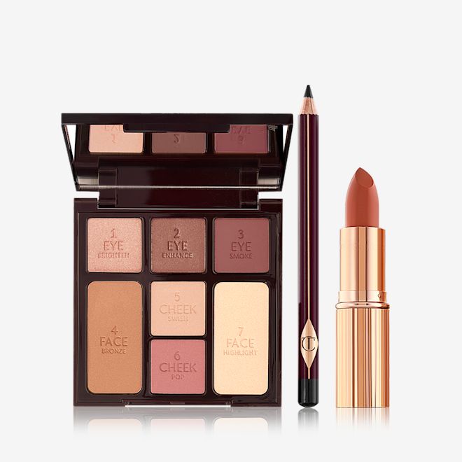 Instant Look in a Kit open An open mirrored-lid face palette with three matte and shimmery eyeshadows, two blushes, and concealer powder, and bronzer with an eyeliner pencil in black, and lipstick in dark terracotta in a golden-coloured tube.