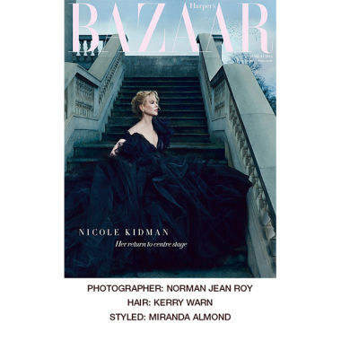 A Harpers Bazaar cover featuring Nicole Kidman wearing a long, flowy, off-the-shoulder black gown. 