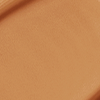 Close-up swatch of a skin-like, glowy foundation in a dark brown shade.