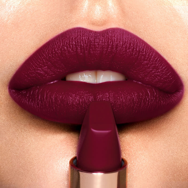 Lips close-up of a light-tone model wearing muted purple berry lipstick with subtle cool-tones and a matte finish.