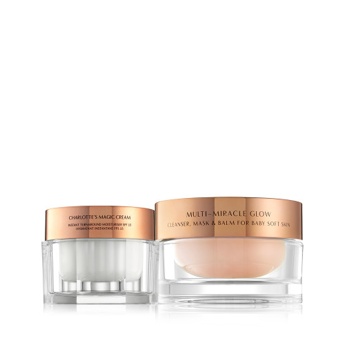 Pearly-white face cream in a glass jar with a gold-coloured lid and a three-in-one cleansing balm in a glass jar with a gold-coloured lid.