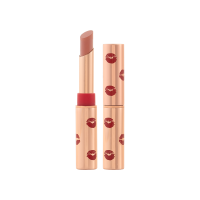 Two identical lipsticks, with and without lid, in a warm peach-nude colour with a matte finish, in gold-coloured tubes with red-coloured kiss print all over the tube.