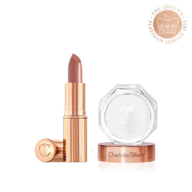 An open lipstick in a soft rosy peach shade with a satin finish in sleek gold-coloured packaging along with pearly white face cream in an open glass jar with a gold-coloured lid.