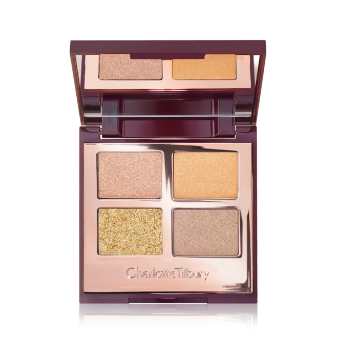 An open, mirrored-lid quad eyeshadow palette with four shimmery shades in champagne, soft gold, coppery-gold and soft bronze.