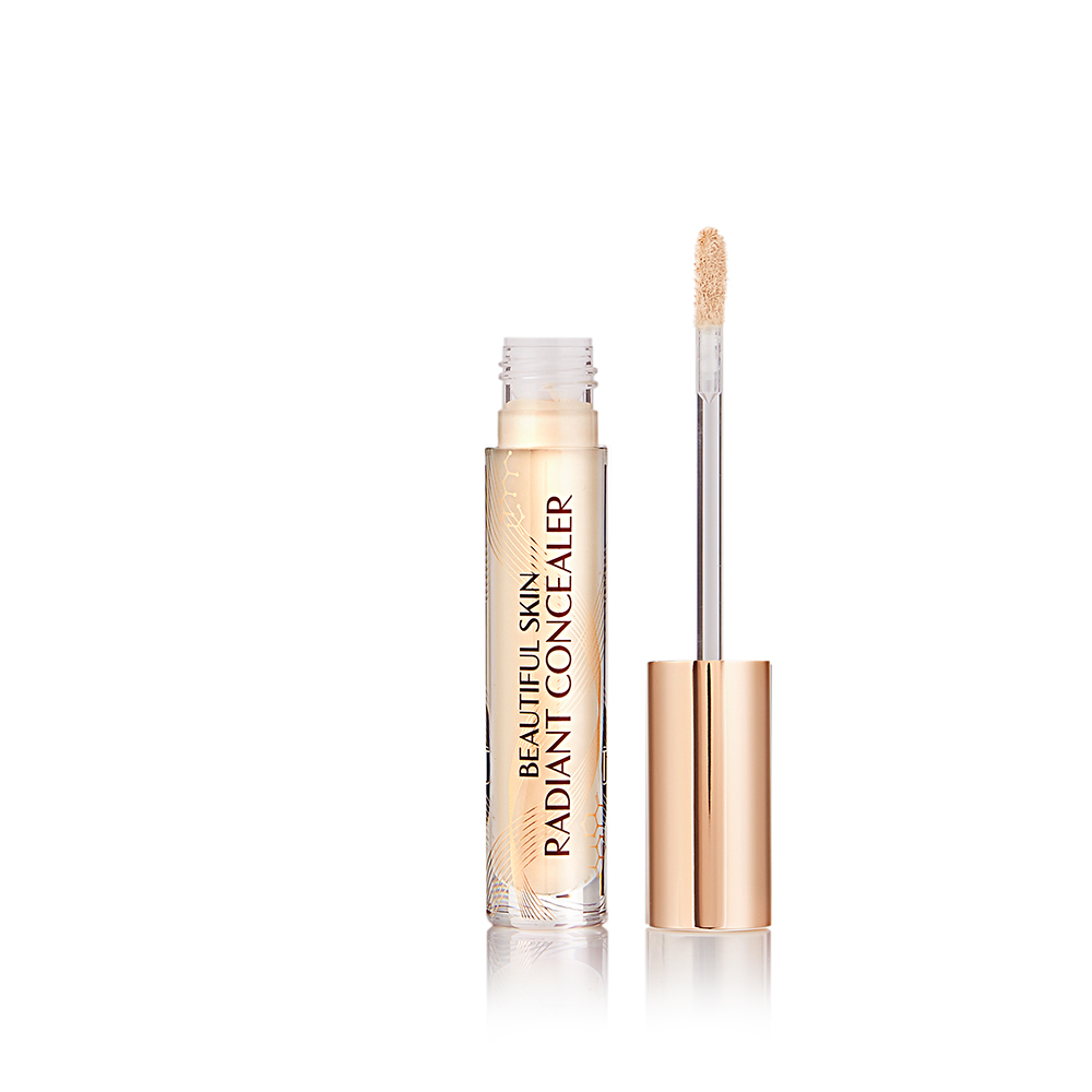 Radiant concealer in a glass tube with its doe-foot applicator next to it with a gold-coloured handle.