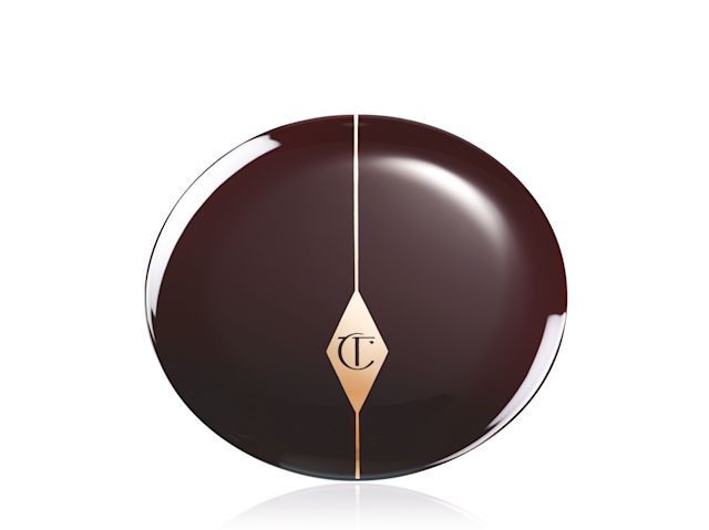 A closed compact blush in a tawny-brown lid with the CT logo printed on it. 