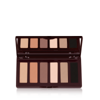 An open, mirrored-lid six-pan eyeshadow palette with matte eyeshadows in brown, peach, and beige shades.