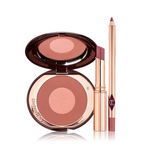 An open, mirrored-lid two-tone blush in shades of terracotta and rose gold with an open lipstick lip balm in sheer berry-rose shade with an open lip liner in pinkish-brown shade. 