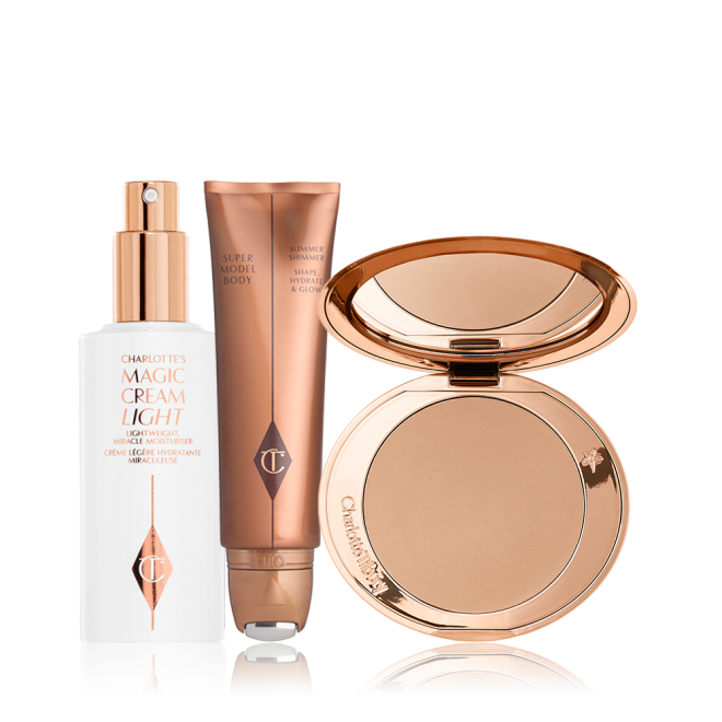 A face cream in a white-coloured bottle with a pump dispenser, body highlighter in a bronze-coloured tube, and a pressed-powder compact with a mirrored-lid. 