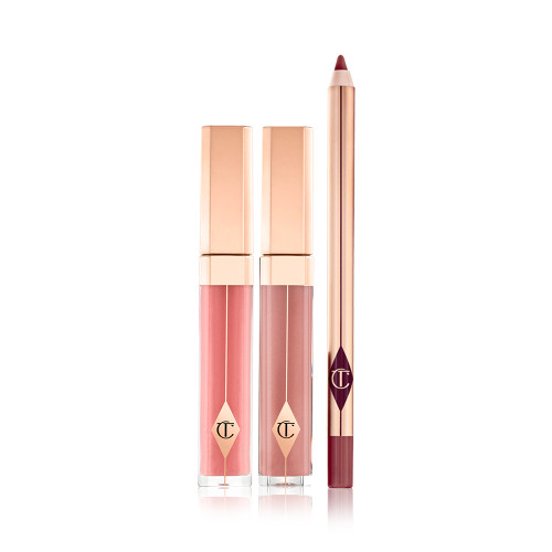 Tow lip glosses in gold-coloured packaging in a nude pink and mauve shades with a lip liner pencil in a maroon shade.