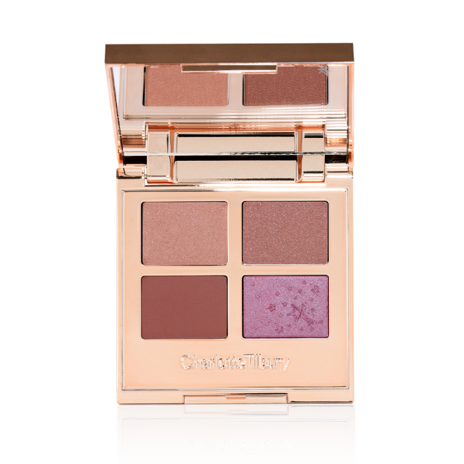 An open, quad eyeshadow palette with a mirrored-lid wth eyeshadows in shades of peachy-pink, dusky rose, warm burgundy, and teal blue-brown.