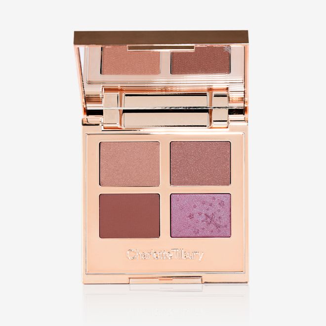 Luxury Palette of Pearls in Cosmic Pearl open An open, quad eyeshadow palette with a mirrored-lid wth eyeshadows in shades of peachy-pink, dusky rose, warm burgundy, and teal blue-brown.