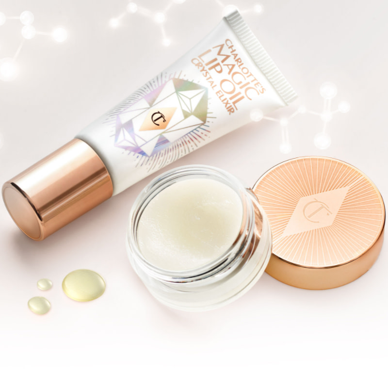 Lip oil in a white-coloured tube with a gold-coloured lid and thick, white-coloured lip scrub in a glass pot with a gold-coloured lid.