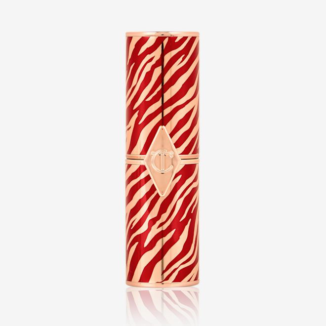 Hot Lips limited edition lipstick closed A closed lipstick in a gold-coloured tube with red flares all across, symbolic of the lunar new year, along with the CT logo embossed on the front.
