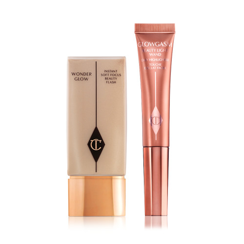 Glowy primer in a clear, rectangular body with a gold-coloured lid and a highlighter blush wand in glowy, medium pink shade. 