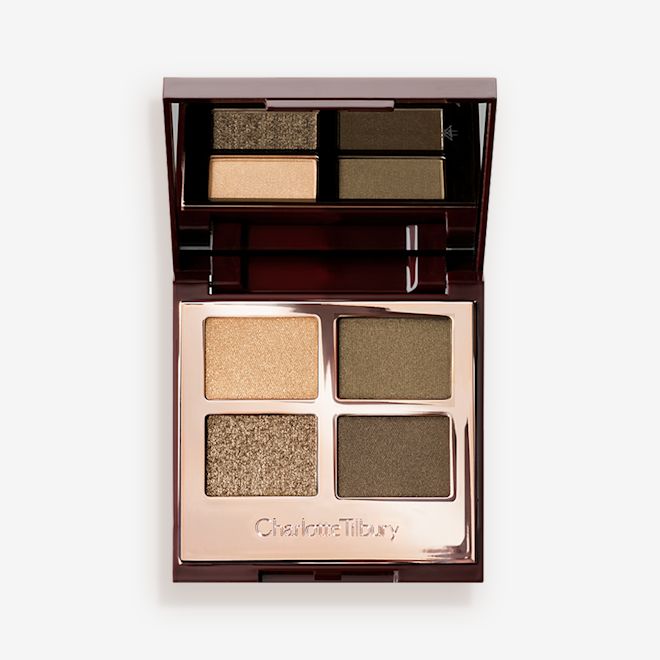 Luxury Palette in Green lights lid open An open, quad eyeshadow palette in rose gold, metallic packaging with a mirrored lid having dark green, olive green, khaki, and golden eyeshadows.