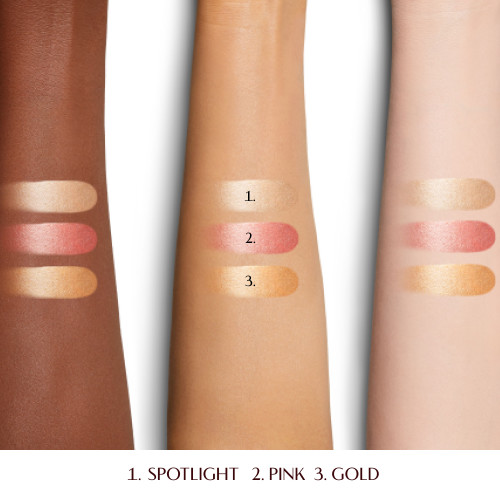 Swatches of three Disney100 x Charlotte Tilbury liquid highlighters in pink, rose gold and gold shades.