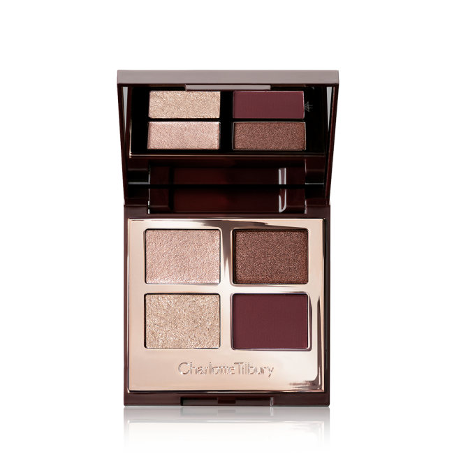 An open, mirrored-lid quad eyeshadow palette with matte and shimmery shades in maroon, dark brown, champagne, and rose gold. 