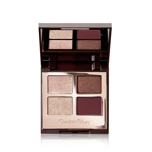 An open, mirrored-lid quad eyeshadow palette with matte and shimmery shades in maroon, dark brown, champagne, and rose gold. 