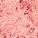 Close-up of a swatch of an eyeshadow pigment in a berry-pink shade.