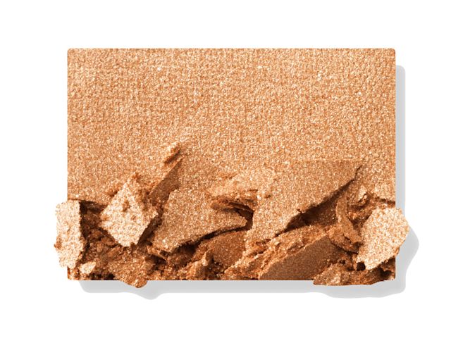 Swatch of a shimmery, powder eyeshadow in a soft, golden shade. 