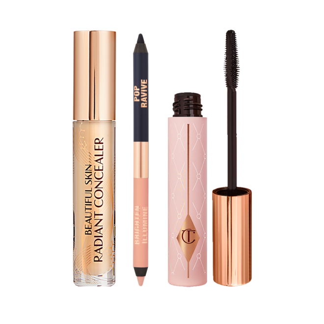 A double-sided eyeliner pencil in jet black and nude beige with an open mascara tube with its applicator next to it, and concealer in a glass tube with a gold-coloured lid with text on the tube that reads, 'Beautiful Skin Concealer'