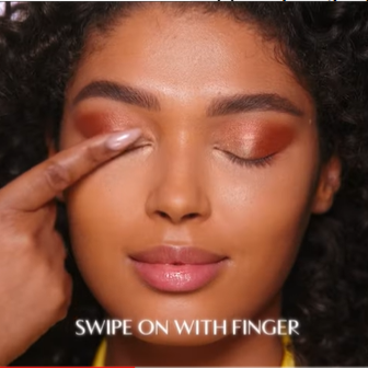 Model wearing Glowgasm Face Palette highlighter as an eyeshadow
