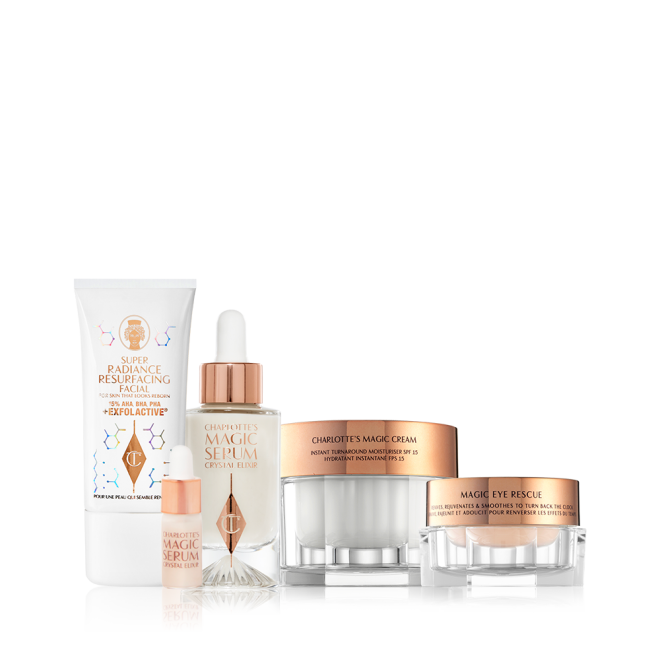 An exfoliating wash-off mask in a white-coloured tube with a luminous, ivory-coloured serum with a dropper lid, pearly-white face cream in a glass jar with a gold-coloured lid, champagne-coloured eye cream in a petite glass jar with a gold-coloured lid.