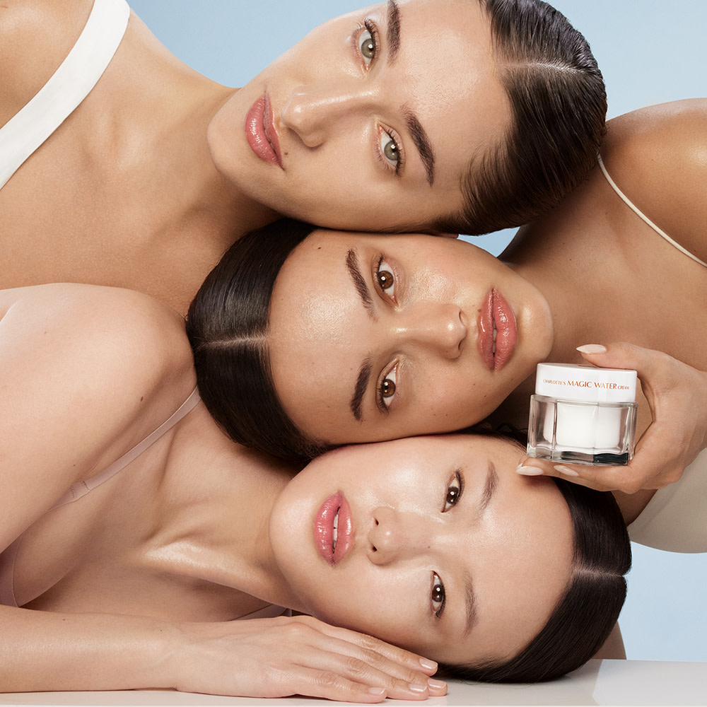 Three models with glowing skin after applying Charlotte's Magic Water Cream gel moisturiser