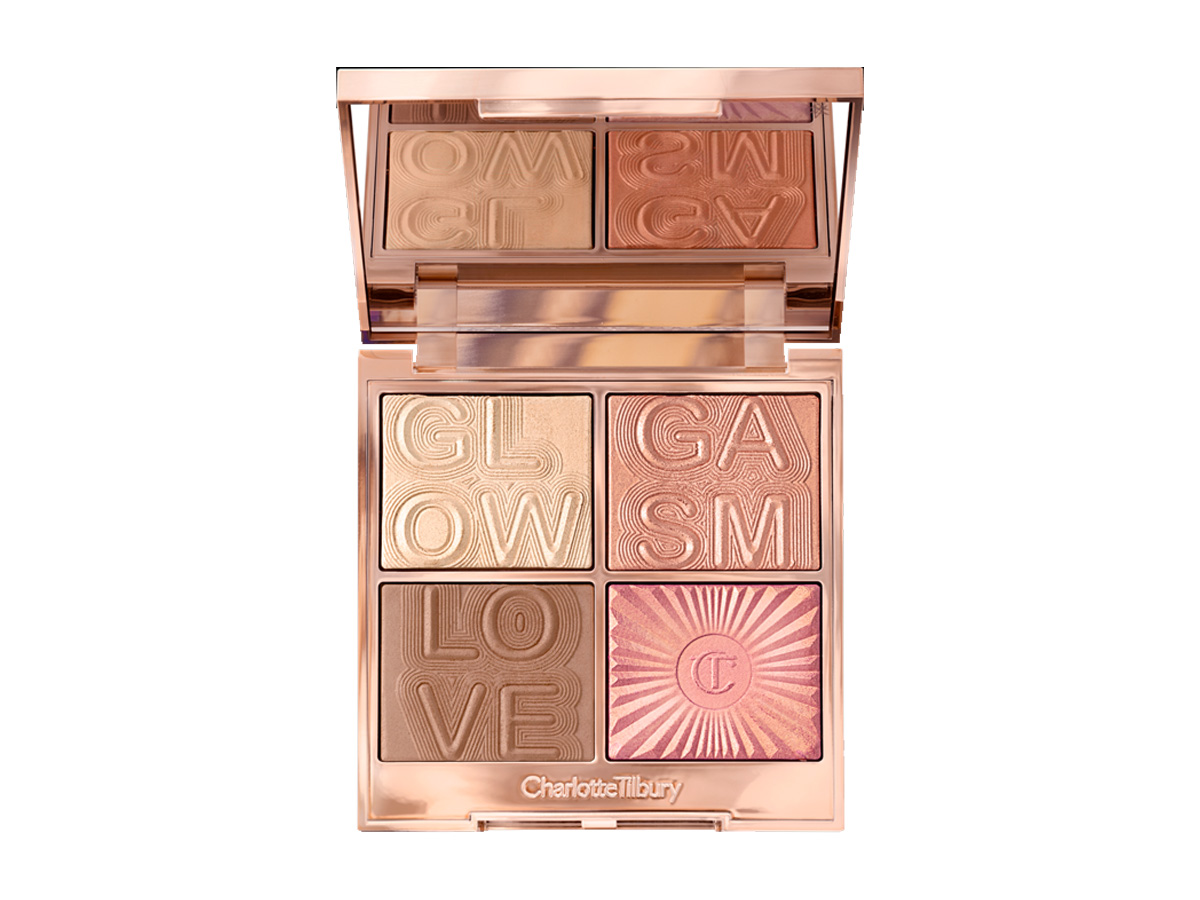 An open, mirrored-lid face palette with a light brown bronzer, a warm-pink glowy blush, and two mega-watt highlighters in terracotta and champagne shades.