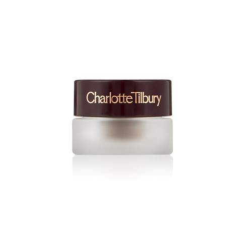 A closed frosted glass pot with cream eyeshadow in a smokey taupe shade with a matte finish with a dark brown lid with Charlotte Tilbury written on the lid in gold. 