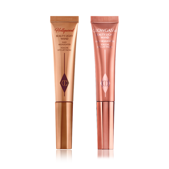 Beauty Light Wands duo closed A highlighter wand and a highlighter blush wand with reflective packaging in rose gold and honey-gold shades.