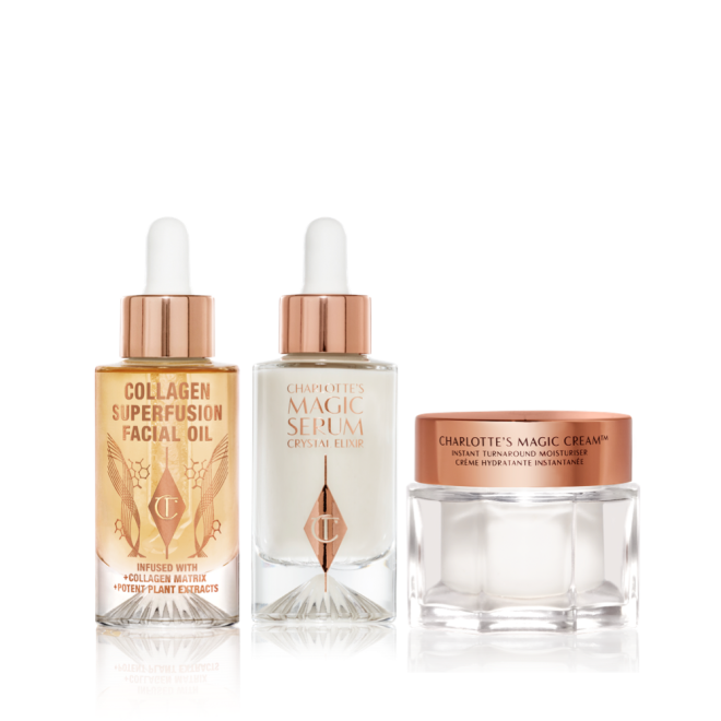 A light-gold-coloured facial oil in a glass bottle with a gold and white-coloured dropper lid, luminous, ivory-coloured facial serum in a glass bottle with a white and gold-coloured dropper lid, and pearly-white face cream in a glass jar with a gold-coloured lid. 