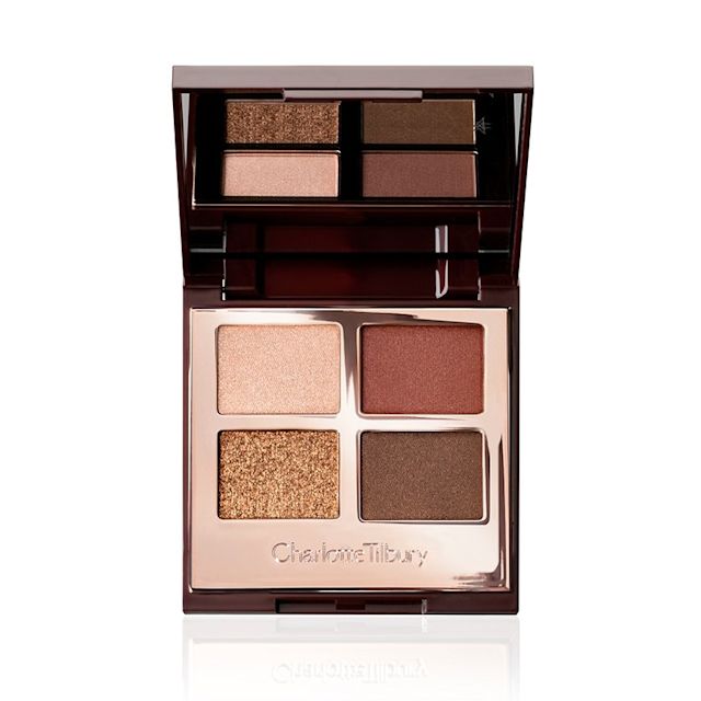 An open, mirrored-lid quad eyeshadow palette with eyeshadows in shades of shimmery brown, dark brown, grey-brown, and dark beige.
