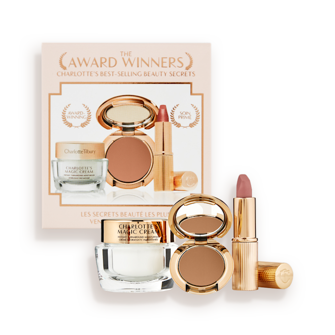 Makeup Starter Kit in Deep displayed Pearly-white face cream in a glass jar with a gold-coloured lid, pressed powder compact in a dark brown shade, and a dusky pink lipstick in a sleek gold-coloured tube.