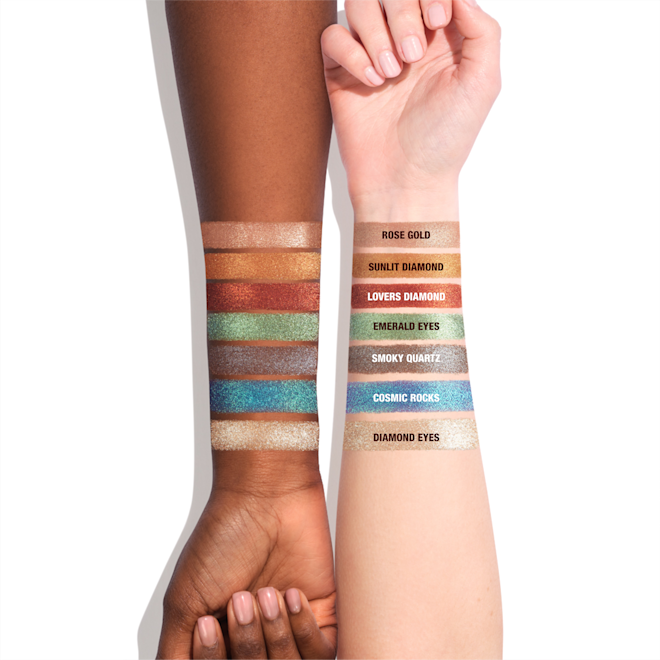 Hypnotising Pop Shots swatches on light-tone and deep-tone arm Light-tone arm with swatches of seven metallic eyeshadows in rose gold, bronze-orange, vibrant red, mint green, lilac-grey, sapphire blue, and opal.