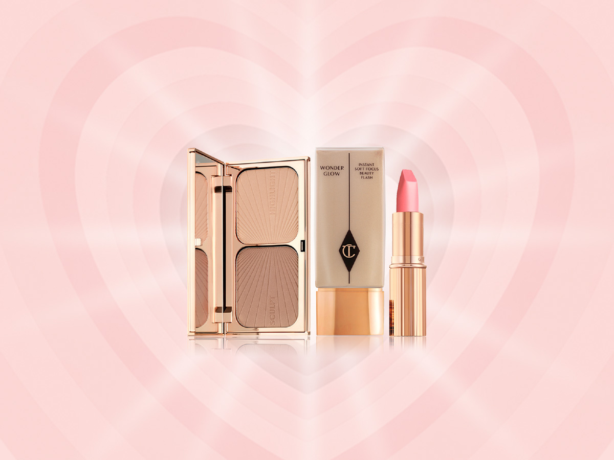 An open, mirrored-lid duo contour palette with a foundation bottle in a light beige shade, and a matte lipstick in a berry-pink shade in a gold-coloured tube.
