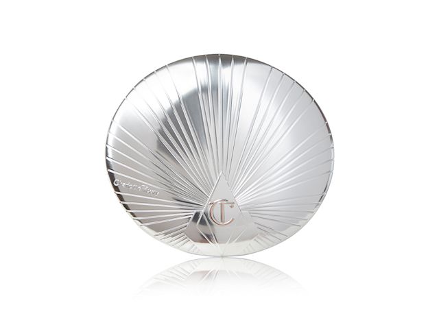 A closed highlighter compact with a silver coloured lid with the CT logo embossed on it. 