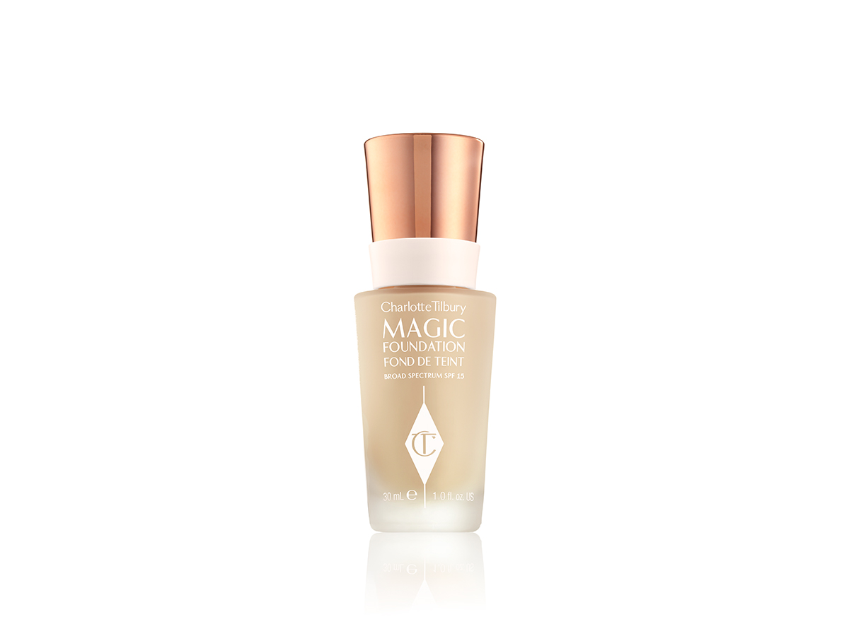 A light beige-coloured foundation in a frosted glass bottle with the CT logo printed on it and a rose gold coloured lid.  