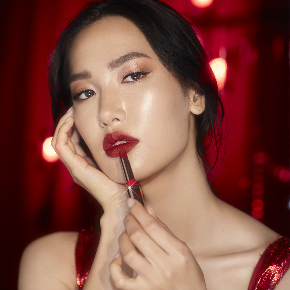 Model Chae applying Limitless Lucky Lips lipstick for custom Christmas gifts gift guide