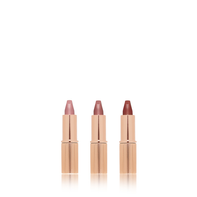 Three, open matte lipsticks in nude pink, pale pink, and berry-rose. 