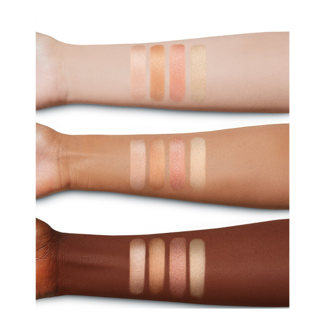 Deep, tan, and fair-tone arms with swatches of four powder highlighters for warm-tone complexions in light pink, coppery-pink, rose gold, and beige-gold.