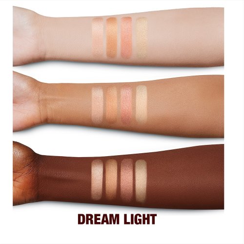 Deep, tan, and fair-tone arms with swatches of four powder highlighters for warm-tone complexions in light pink, coppery-pink, rose gold, and beige-gold.